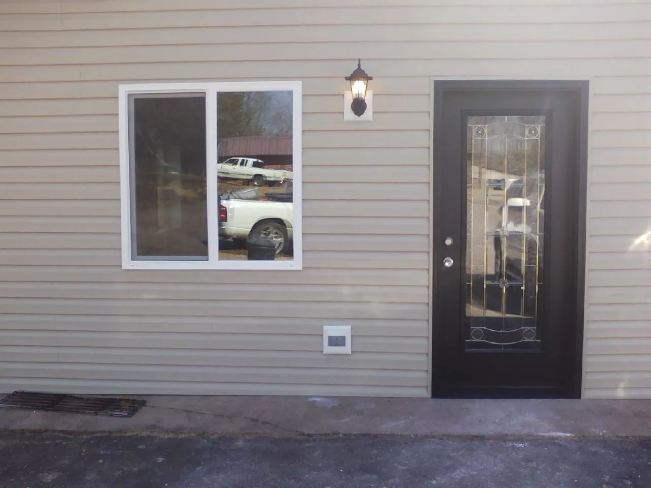 New siding, window and entry door on the side of an addition in Folkston